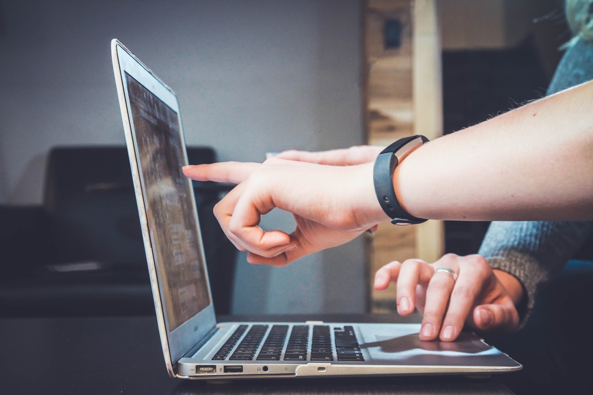 People discussing ideas beside an open laptop